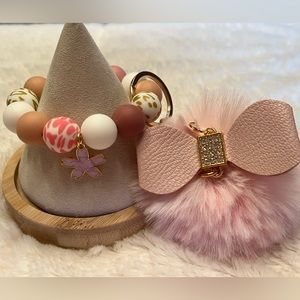 Keychain Wristlet. 
Silicone beaded bracelet with a pastel pink Pom Pom.